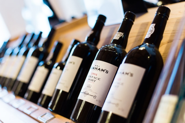 Row of port wine bottles on a display rack